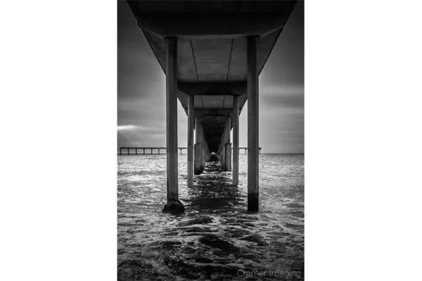 Cramer Imaging's quality black and white landscape photograph of the Pacific Ocean under the San Diego California pier