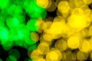 Cramer Imaging's professional quality fine art photograph of yellow and green blurry Christmas lights