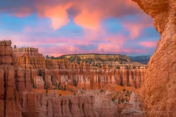 Cramer Imaging's fine art landscape photograph of fiery orange clouds lighting up over the Boat Mesa in Bryce Canyon National Park Utah