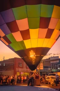 Cramer Imaging's fine art photograph of the Panguitch Utah hot air balloon glow on main street with a jet of fire showing