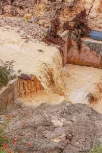 Cramer Imaging's photograph of a flash flood hours after onset traveling down a waterway full of silt