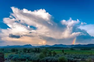 Cramer Imaging's fine art landscape photograph of a rainbow displayed against a dramatic monsoon cloudscape in rural Utah