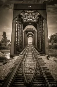 Cramer Imaging's professional fine art photograph of a railroad or train bridge over a river between Fremont and Madison counties, Idaho