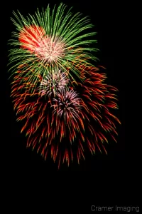 Cramer Imaging's professional quality fine art photograph of green, red, and white fireworks against the sky