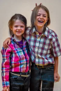 Portrait of a brother and sister child siblings in plaid professionally photographed