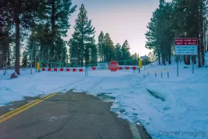 Photograph of the road to Cedar Breaks National Monument blocked off by a gate and snowfall