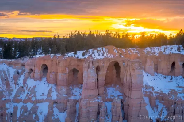 Cramer Imaging's fine art landscape photograph of a winter sunburst sunset at Bryce Canyon National Park Utah