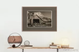 Photograph of a room containing a shelf with rustic decorations and a framed copy of Cramer Imaging's "Rustic" landscape photo