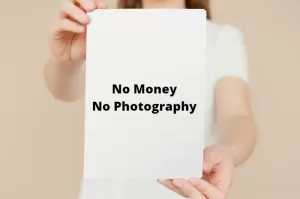 Photo of a woman holding a sign saying" no money, no photography"