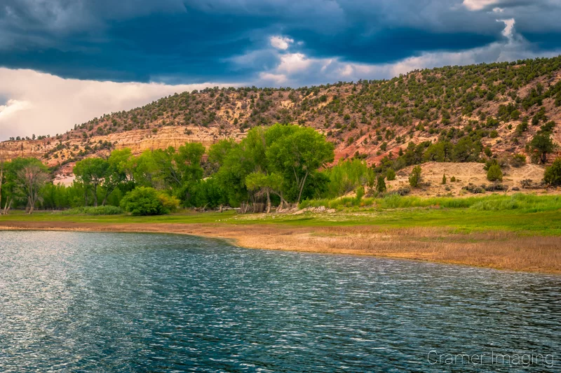 Fine art landscape photograph of moody monsoon skies and troubled waters at Wide Hollow Reservoir in Escalante, Utah by Cramer Imaging