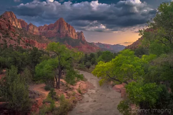 Cramer Imaging's fine art landscape photograph of a moody summer evening view of the Virgin River and Watchmen peak at Zion National Park Utah