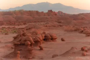 Cramer Imaging's fine art landscape photograph of red hoodoo mushroom rock formations against mountain at Goblin Valley State Park Utah