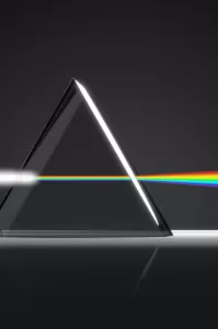 Image of white light entering a prism and exiting refracted as a rainbow