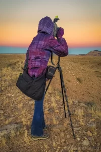 Professional landscape photographer Audrey Cramer photographing Cathedral Valley at sunset