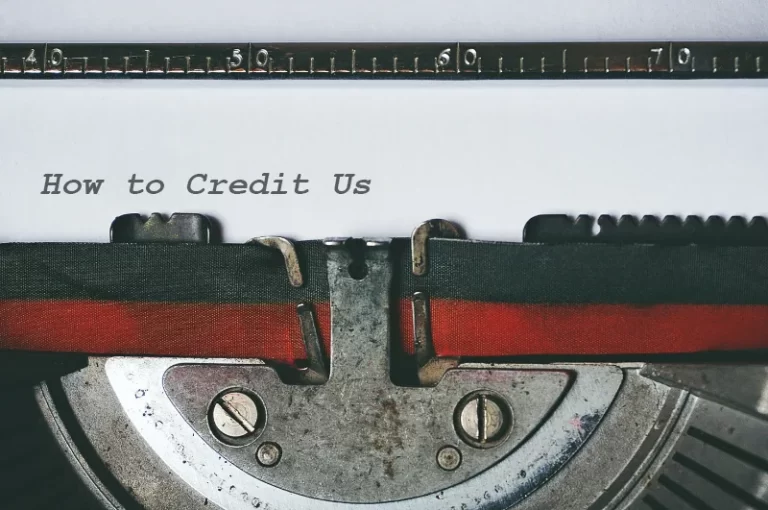 "How to Credit Us" typed out on paper from a typewriter with zoom-in