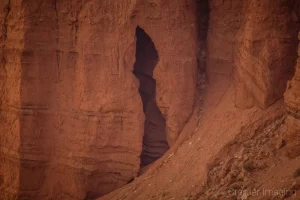 Cramer Imaging's fine art landscape photograph of a hole or cave in red rock at Capitol Reef National Park Utah