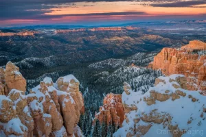 Fine art landscape photograph of warm, winter, dramatic sunset over snowy Rainbow Point, Bryce Canyon National Park, Utah