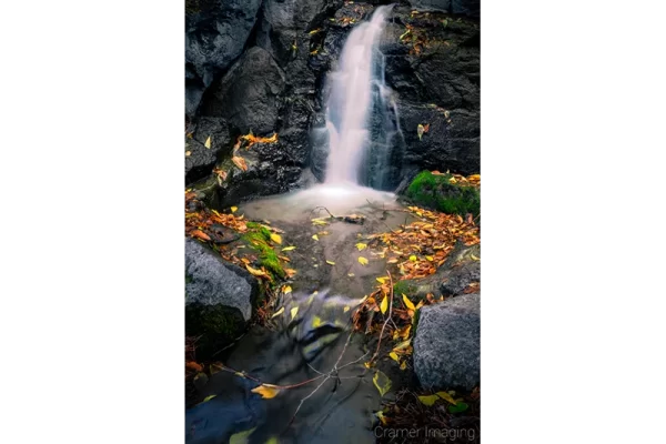 Cramer Imaging's fine art landscape photograph of mini waterfall and pool with fallen autumn leaves