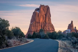 Fine art landscape photograph of a road passing by large monolith rock at sunset in Kodachrome State Park Utah by Cramer Imaging