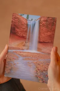 Photograph of hands holding a book with Cramer Imaging's landscape photograph "Ethereal" on the cover