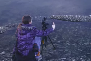 Landscape photographer Audrey Cramer setting up a landscape panorama photo at Henry's Lake Idaho