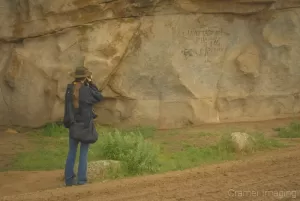 Cramer Imaging's professional landscape photographer Audrey Cramer photographing the pioneer signatures on Signature Rock at City of Rocks, Idaho