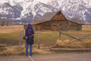 Cramer Imaging's photograph of landscape photographer Audrey Cramer taking a Moulton Barn picture at Grand Teton National Park Wyoming