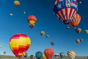 Cramer Imaging's fine art photograph of lots of hot air balloons taking flight in Panguitch Utah with a blue morning sky