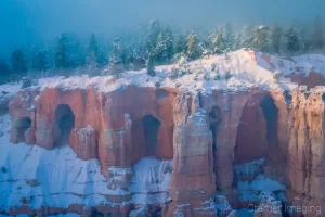 Cramer Imaging's fine art landscape photograph of dawn rising over magical fog the landscape of Bryce Canyon National Park, Utah