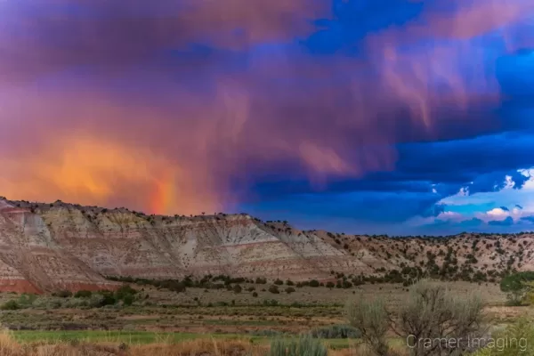 Cramer Imaging's fine art landscape photograph of dramatic clouds and a rainbow above the Cannonville Utah landscape