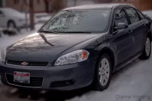 Photograph of a sedan style grey car parked on snow by Cramer Imaging