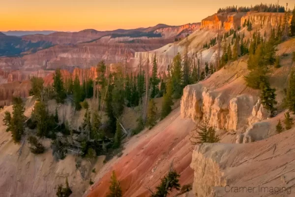 Cramer Imaging's fine art landscape photograph of golden sunset light illuminating Cedar Breaks National Monument Utah