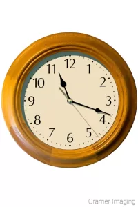 Cramer Imaging's professional quality stock photograph of a wooden wall clock on a white background