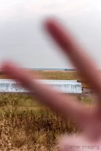 Cramer Imaging's photograph of a single finger closing a panorama series of landscape photos