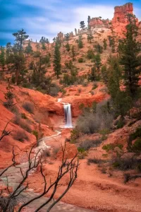 Cramer Imaging's fine art landscape photograph of a waterfall and red hoodoos at Bryce Canyon National Park, Utah