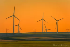 Cramer Imaging's landscape photograph of windmills or wind turbines in a field at sunset in Ririe, Idaho