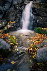 Cramer Imaging's fine art landscape photograph of mini waterfall and pool with fallen autumn leaves