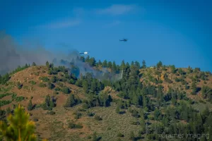 Cramer Imaging's landscape photograph of a helicopter dropping water on a wildfire near Panguitch Lake Utah