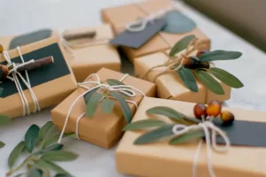 Brown paper packaged tied with string and decorated with leaves and seeds