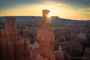 Cramer Imaging's fine art landscape photograph of the sun peeking around the Thor's Hammer hoodoo in Bryce Canyon National Park, Utah