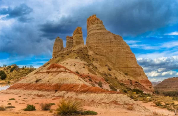 Cramer Imaging's fine art landcape photograph of a giant rock formation against dramatic skies in Cannonville Utah