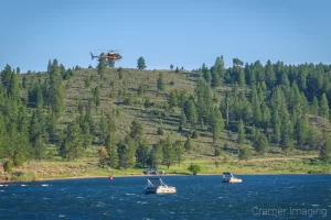 Cramer Imaging's photograph of a helicopter filling a bucket with water out of Panguitch Lake for wildfire fighting