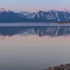 Cramer Imaging's professional quality landscape photograph of mountains and a cabin reflecting in Henry's Lake at dawn