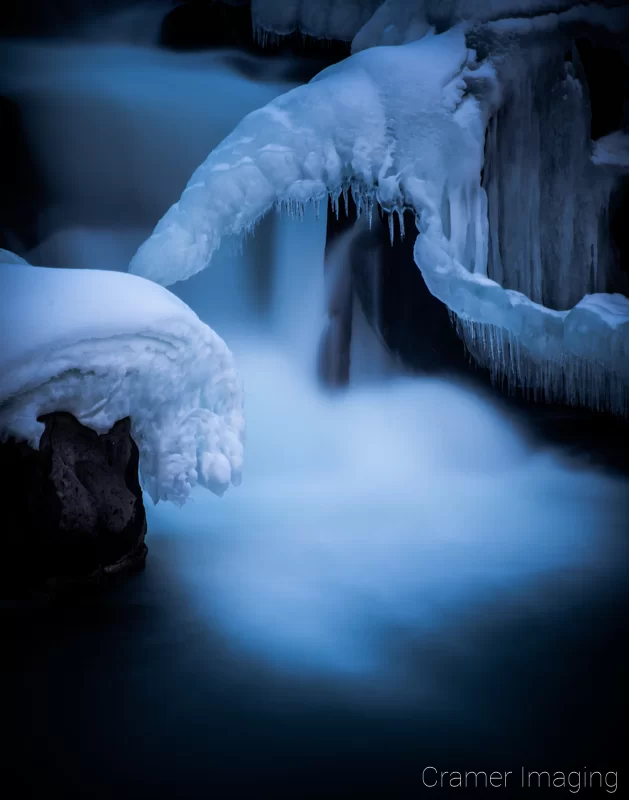 Cramer Imaging's nature photograph of a silky waterfall in the snow during winter in Idaho Falls, Idaho