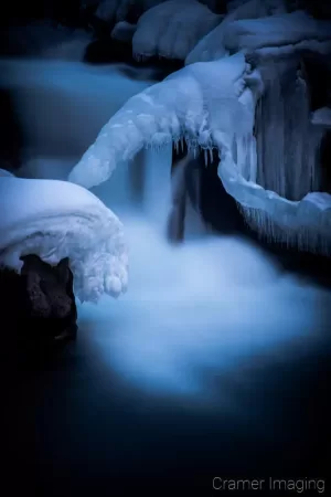 Cramer Imaging's nature photograph of a silky waterfall in the snow during winter in Idaho Falls, Idaho