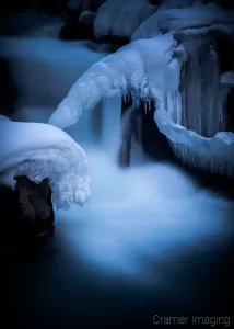 Cramer Imaging's nature photograph of a silky waterfall in the snow during winter in Idaho Falls, Idaho