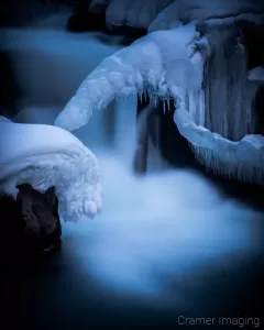 Cramer Imaging's nature photograph of a silky waterfall in the snow during winter in Idaho Falls, Idaho