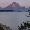 Cramer Imaging's quality landscape photograph of Jackson Lake reservoir with mist at sunrise in Grand Teton National Park Wyoming