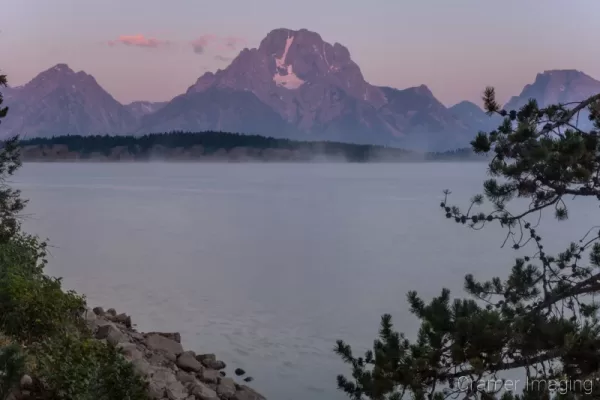 Cramer Imaging's quality landscape photograph of Jackson Lake reservoir with mist at sunrise in Grand Teton National Park Wyoming