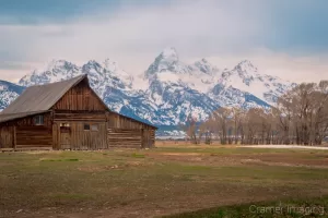 Cramer Imaging's fine art landscape photograph of the Moulton Barn against the mountains of Grand Teton National Park Wyoming